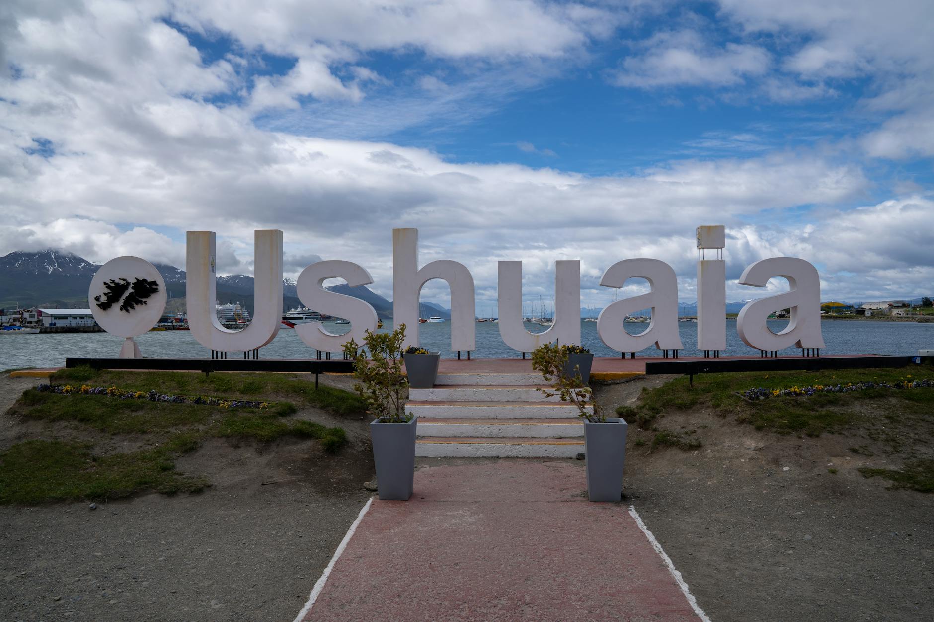 ushuaia sign with scenic mountain backdrop